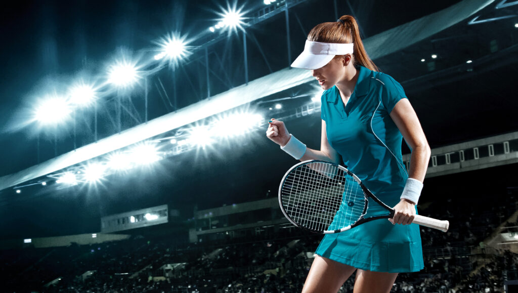 Female tennis player relishing a dominating victory after engaging in mental visualization for tennis players.