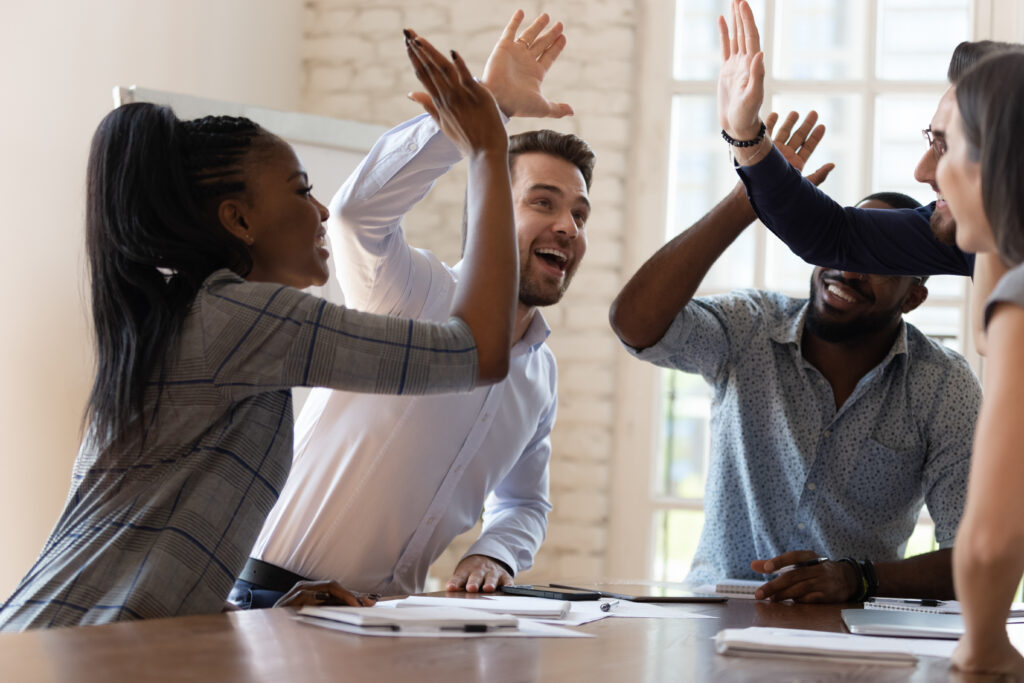 Business people celebrating a successful session learning sales coaching strategies